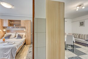 A modern hotel room with a bed, a small table, a sofa, and a dining area. - Sea View Apt Silver near Zadar, Jasenice, Croatia (Jasenice)