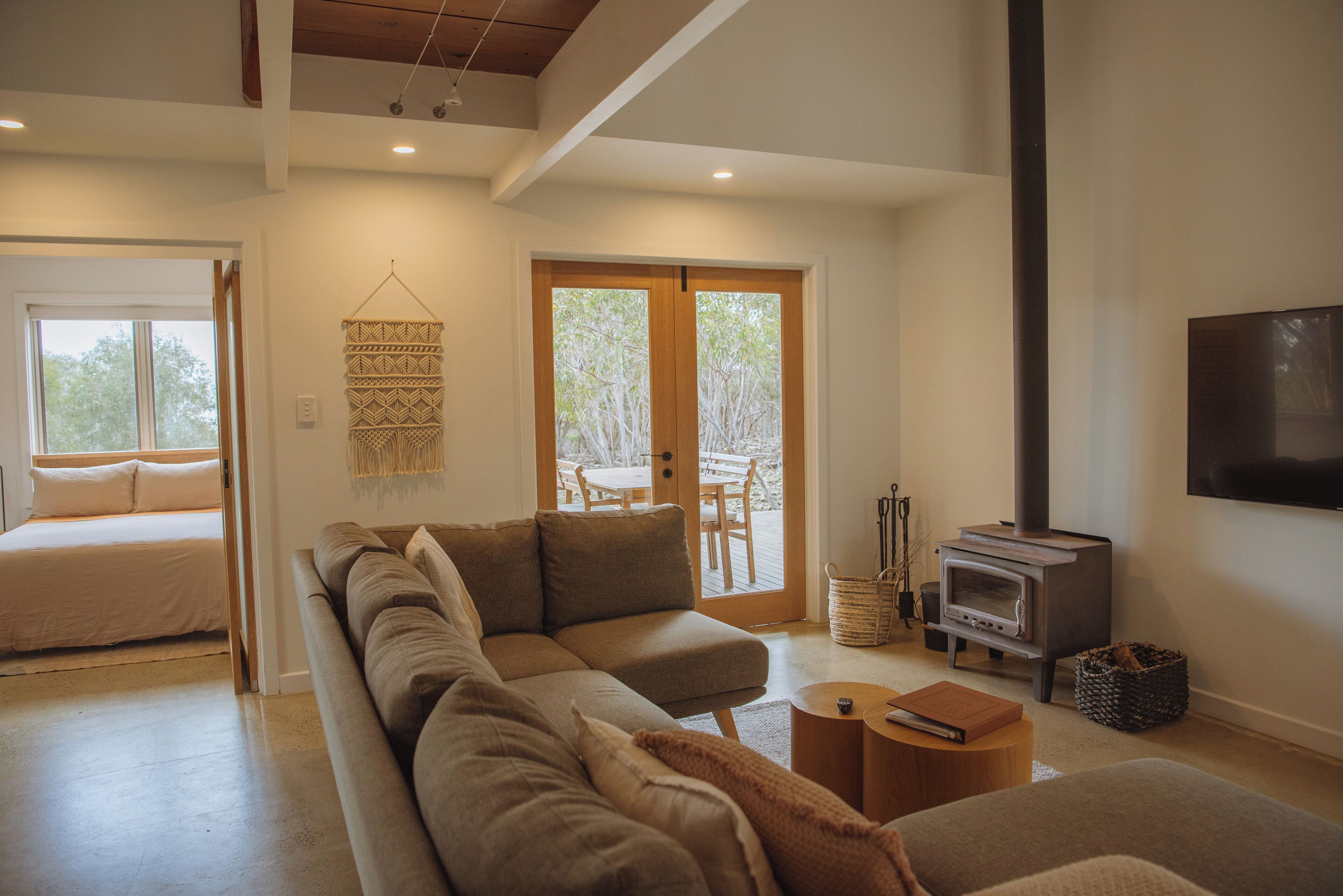 A modern living room with a sectional sofa, a fireplace, and a dining area with a table and chairs.