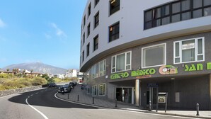 A multi-story building with a sign for 'ENERO DECO' and a visible entrance. - Vacation Home "Apartamento Vistas de Icod" with Mountain View, Sea View & WiFi (Icod de los Vinos)