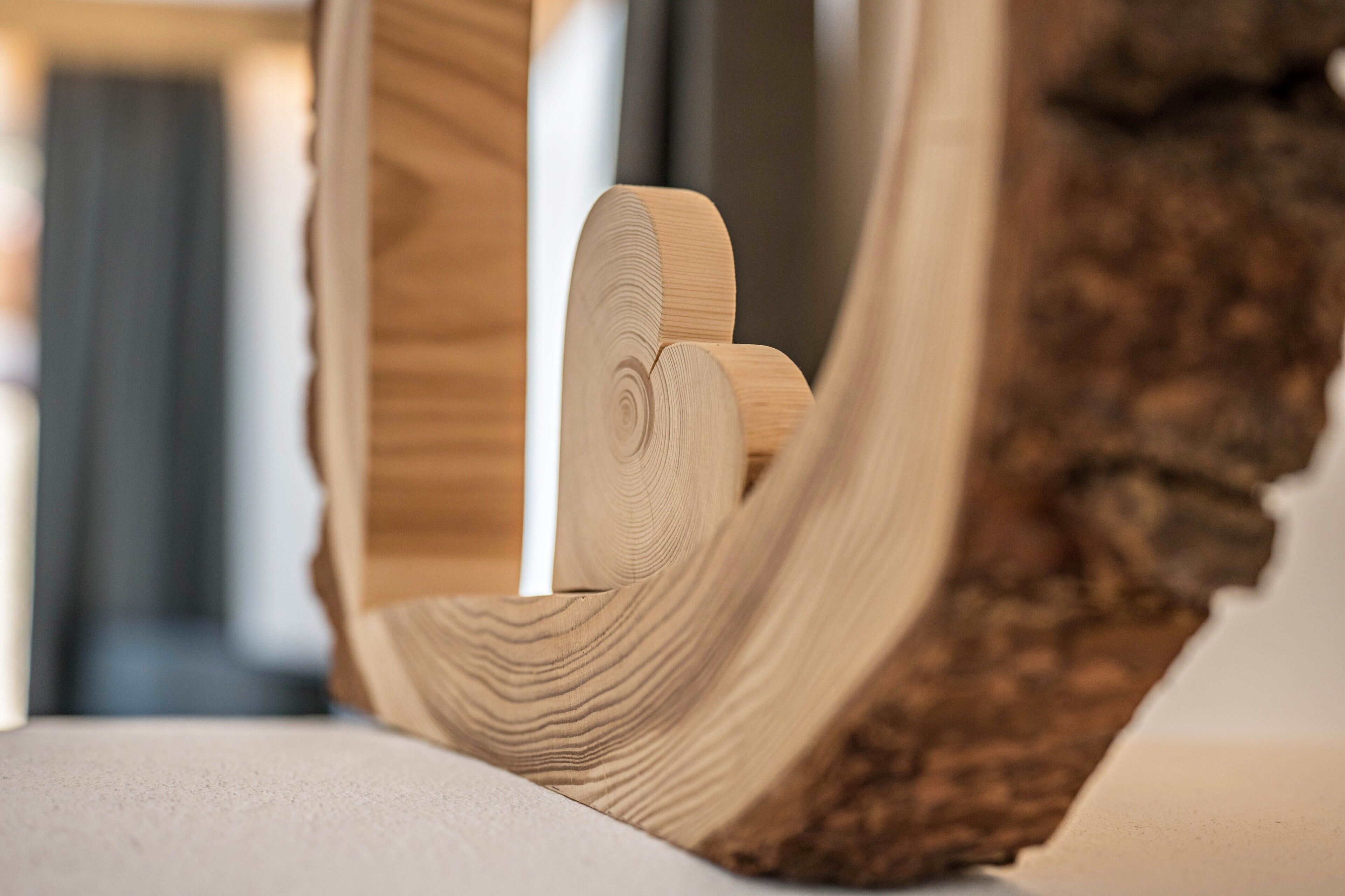 A close-up of a wooden object with a natural grain pattern, possibly a piece of furniture or decor.