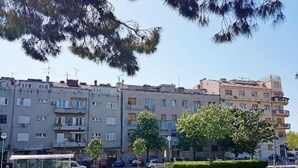 A residential area with multi-story buildings, a paved walkway, and a grassy park area. - Park Apartment (Split)