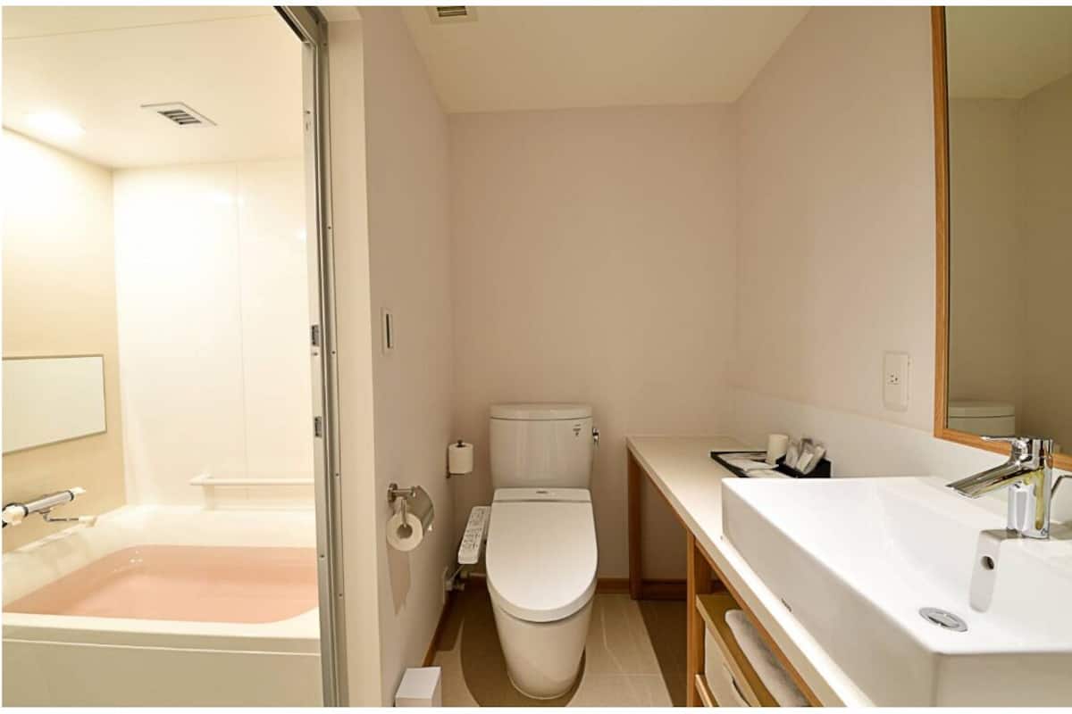 A bathroom with a bathtub, toilet, and sink.