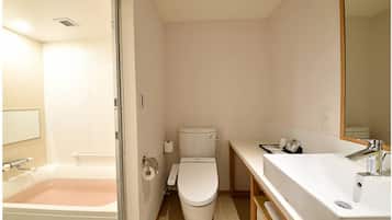 A bathroom with a bathtub, toilet, and sink.
