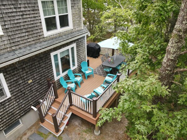 A deck with outdoor furniture, a grill, and a covered area. - Close to Bass River and Follins Pond With Water Access (2232) (South Yarmouth)