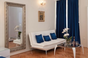 Relax in this stylish living room with a sofa, mirror, and coffee table.