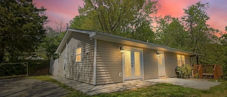 A single-story house with a front porch, a garage, and a small deck.