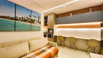 Family Apartment, Pool View | Living area | Flat-screen TV