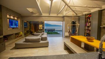 Villa | Living room | 65-inch Smart TV with cable channels, TV, fireplace