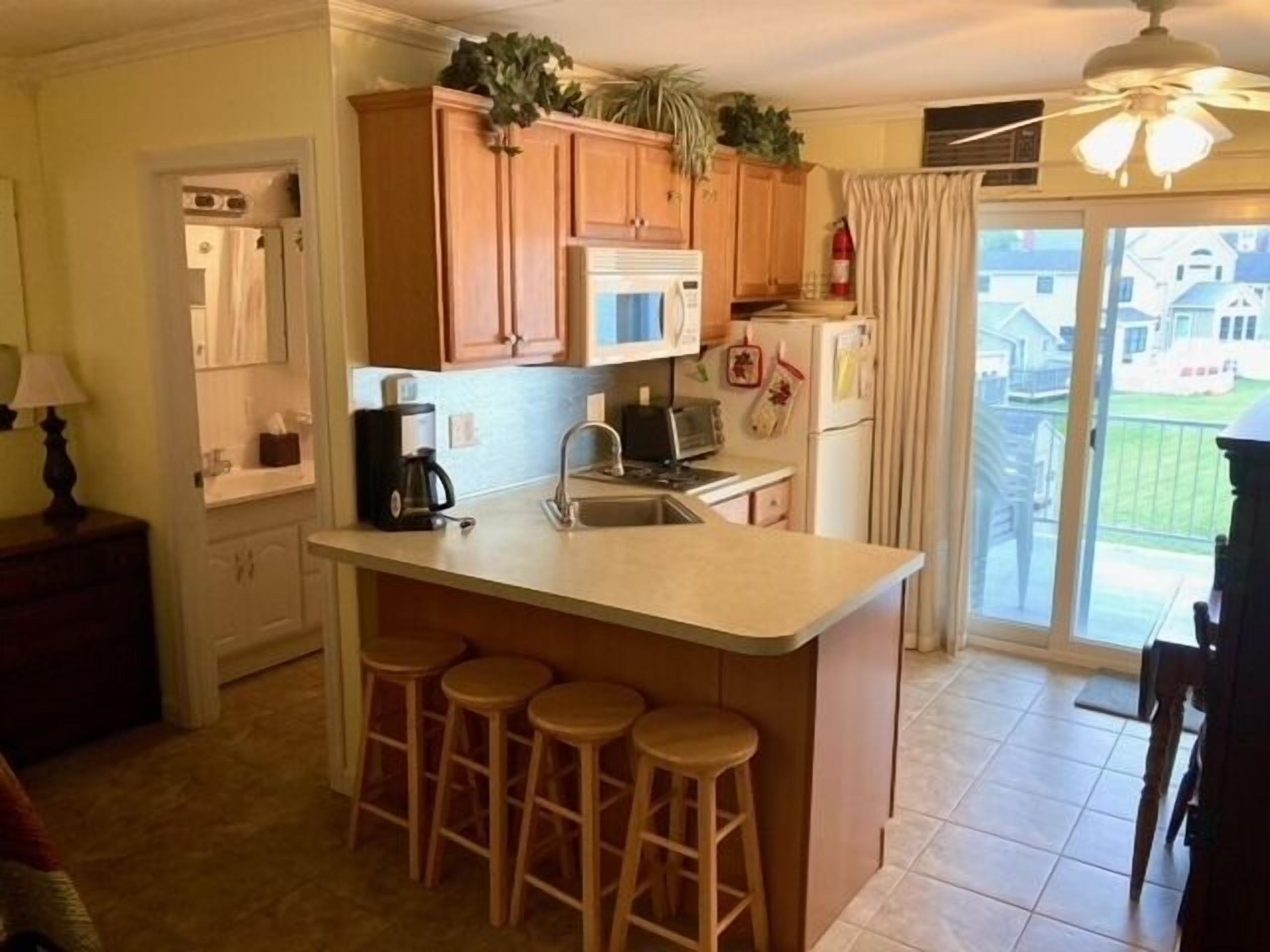 Fridge, microwave, stovetop, coffee/tea maker