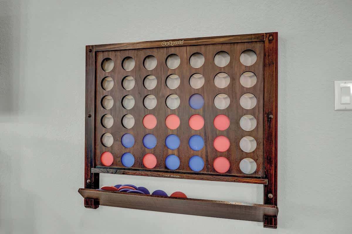A GoSports board with a wooden frame and a white wall background.