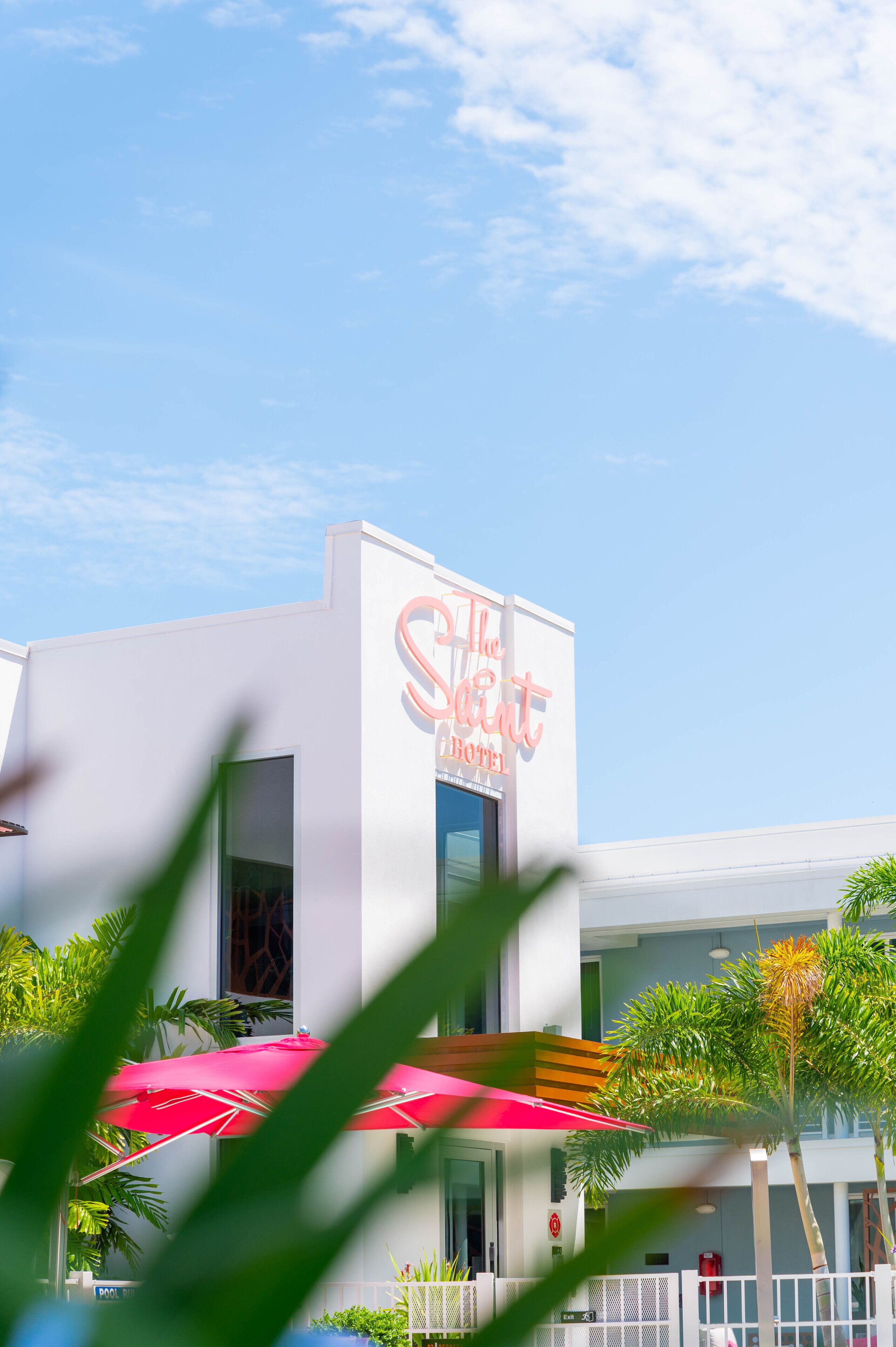 A modern hotel with a prominent sign reading "The Secret Hotel".