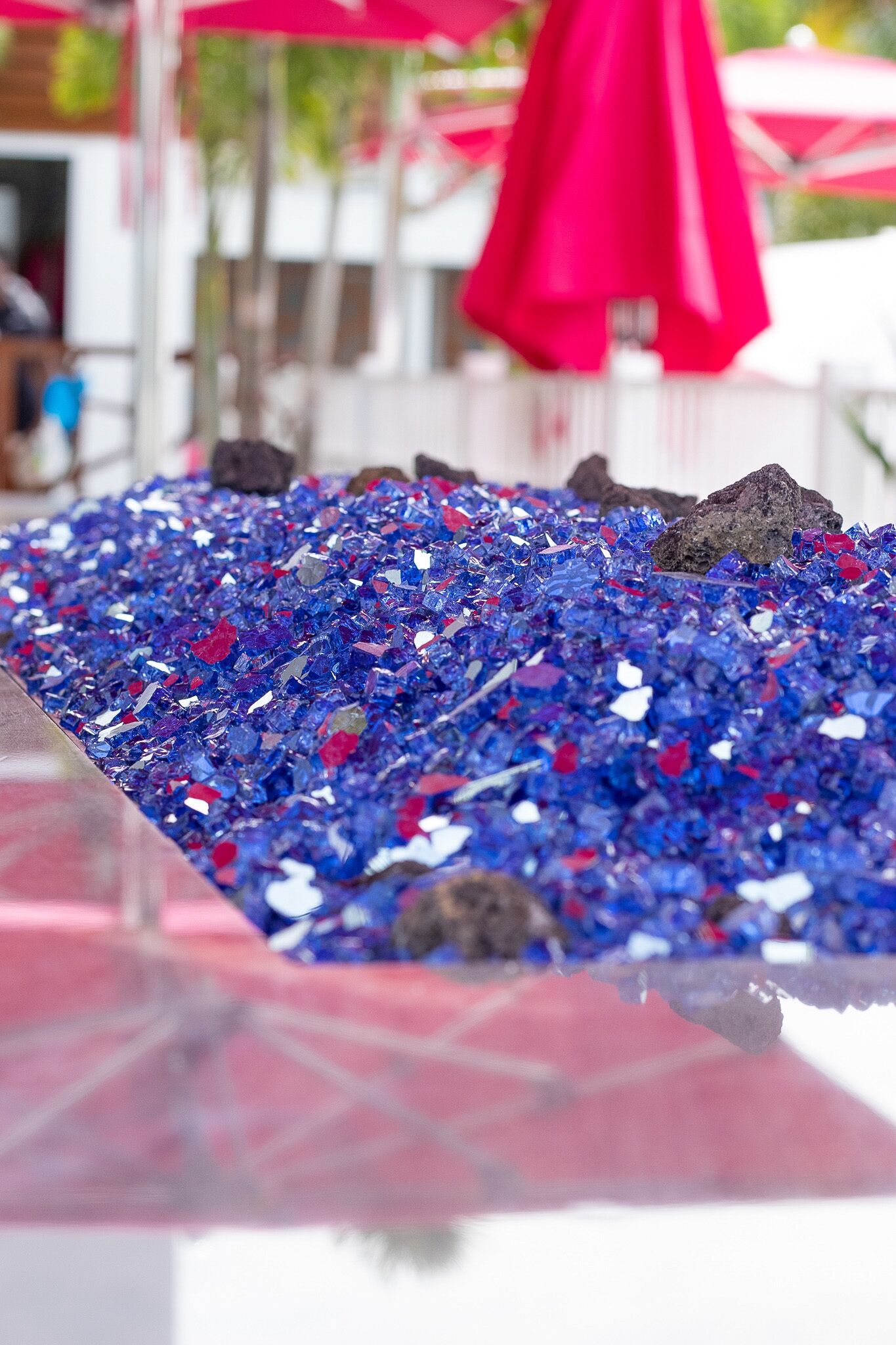 A table covered with blue and red glass pieces.