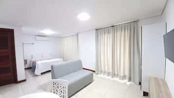 Family Studio, Pool View | Living area | 32-inch flat-screen TV with satellite channels, TV