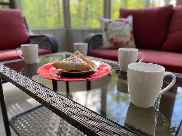 A glass-top table with a red placemat, two white cups, and a plate with pastries. - "The Desoto Oasis" @ Hot Springs Village (Hot Springs)