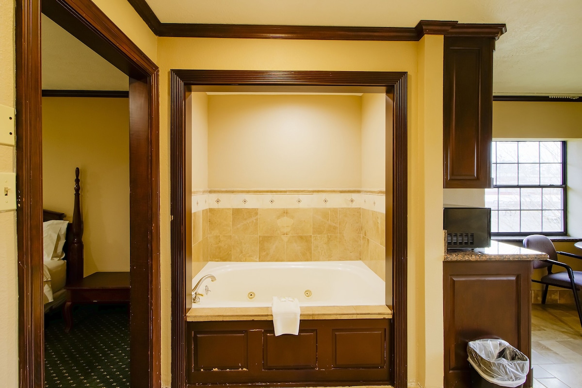 A bathroom with a bathtub, a toilet, and a sink.