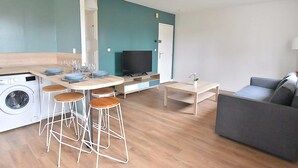 A compact living space with a kitchen, dining area, and seating area. - Cosy, fully-equipped, refurbished F2 (Vert-le-Grand)