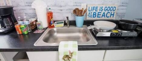 Microwave, dishwasher, coffee/tea maker, cookware/dishes/utensils