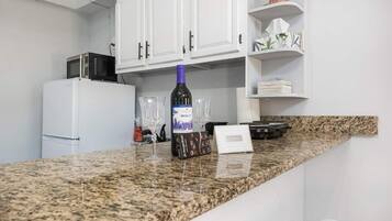 Fridge, microwave, stovetop, coffee/tea maker