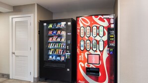 Two vending machines, one with a Coca-Cola logo and the other with a variety of snacks. - Red Roof Inn Chester (Chester)