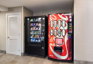 Two vending machines, one with a Coca-Cola logo and the other with a variety of snacks. - Red Roof Inn Chester (Chester)