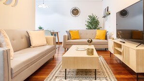 A modern living room with a sofa, a coffee table, and a TV. - Amplio y recién reformado en Indautxu (Bilbao)