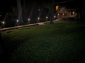 Stroll along the well-maintained grassy area to a serene wooden deck, perfect for relaxation.