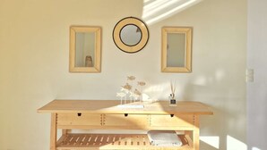 A room with a wooden desk, two wall-mounted mirrors, and a hanging round mirror. - Beautiful twin villa of 100m² for 6 people (BISCARROSSE)