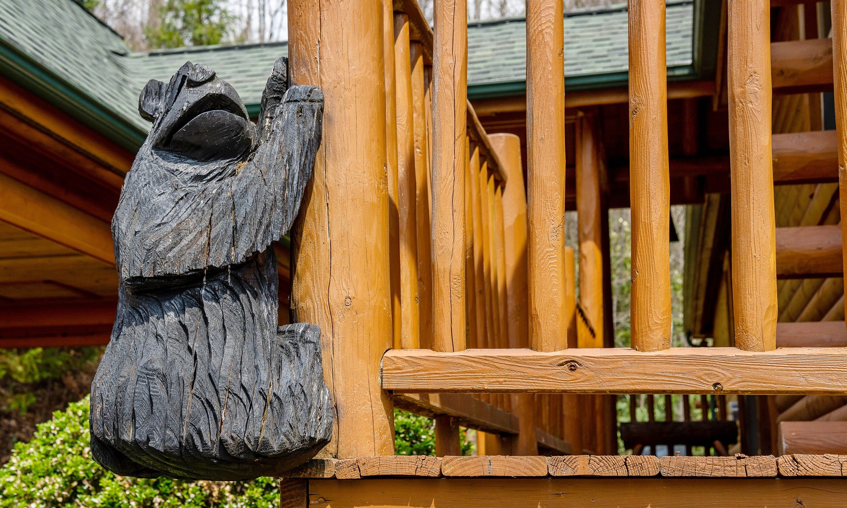 A wooden fence with a carved frog figure.