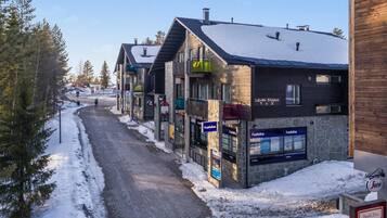 A row of modern buildings with 'habita' signs, a 'Levin Stara 1 & 2' sign, and a 'Pasta & Pizza' sign.
