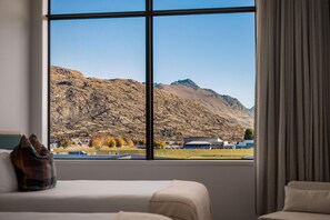 A hotel room with a large window offering a mountain view. - Sudima Queenstown Five Mile (Queenstown)