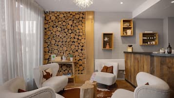 A modern interior with a fireplace, seating area, and wooden wall decor.