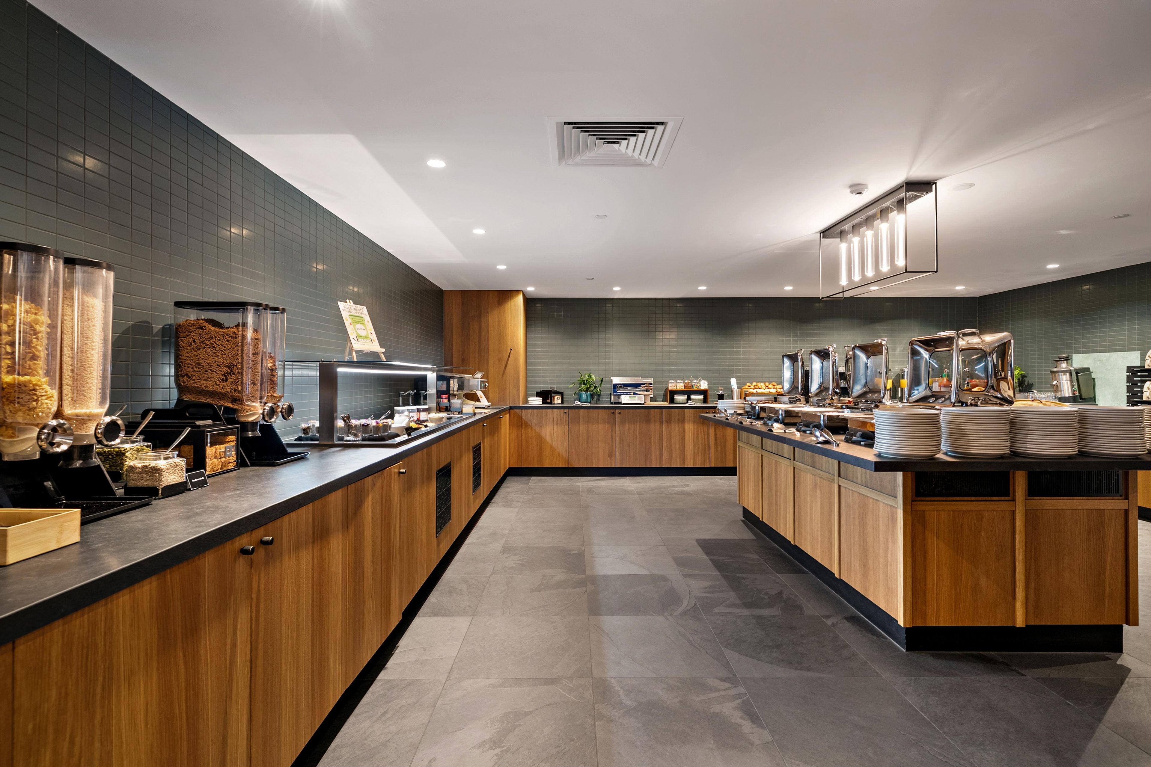 A modern kitchen with wooden cabinets, a central island, and a variety of appliances.