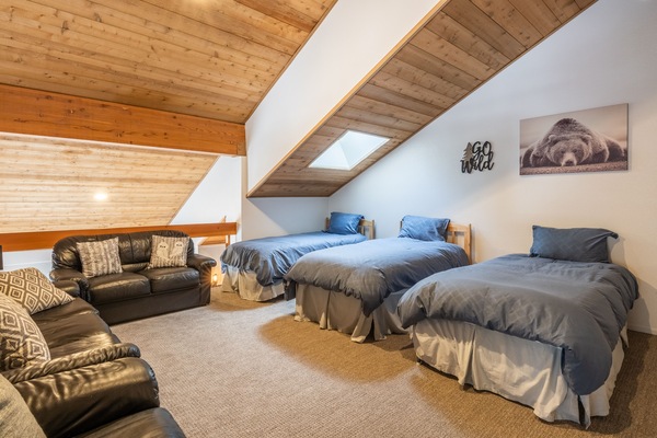 upstairs loft with 4 twin beds total. One twin is pull out trundle twin