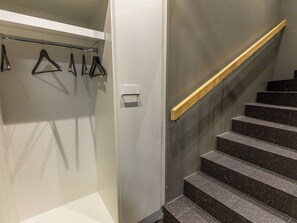 A staircase with a wooden handrail leading to a landing.