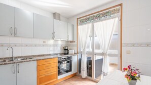 A kitchen with white cabinets, a stove, and a sink. - Holiday Home "Ana House" with Sea View, Wi-Fi & Terrace (CAN PASTILLA)