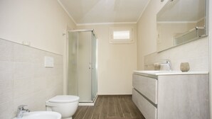 A bathroom with a toilet, bidet, and shower. - Silvia Loft on Hill between Green & White Coast (Portoferraio)