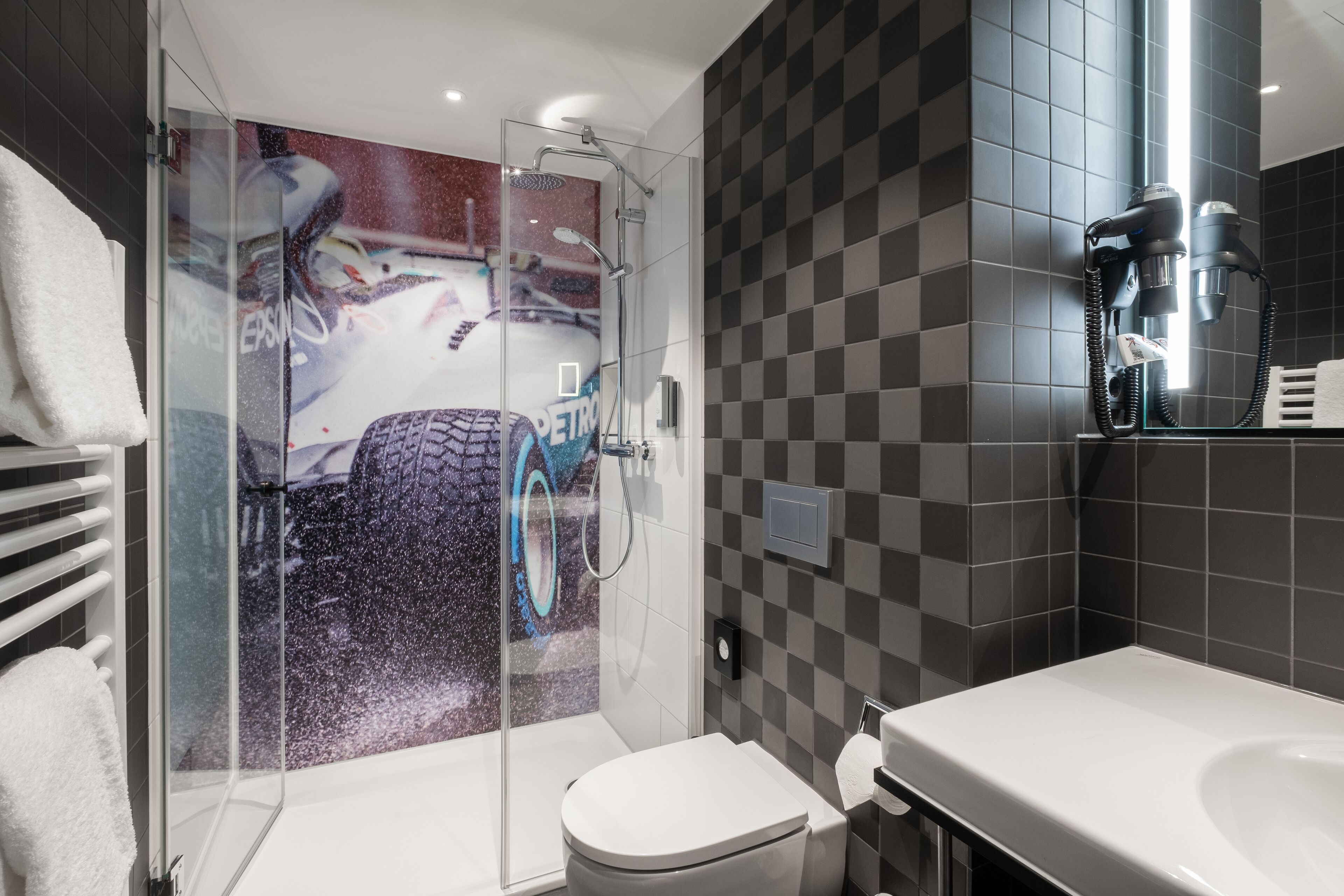 racing suite | bathroom | shower, rainfall showerhead, hair dryer, towels