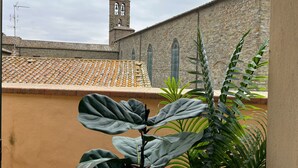A building with a tiled roof and a bell tower. - Cortonas Rooftop Nest (Cortona)