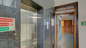An elevator interior with a sign indicating a fire case and instructions not to use the lift. - Treebo TMS Residency (New Delhi)