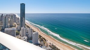 A coastal cityscape with high-rise buildings, a beach, and the ocean.