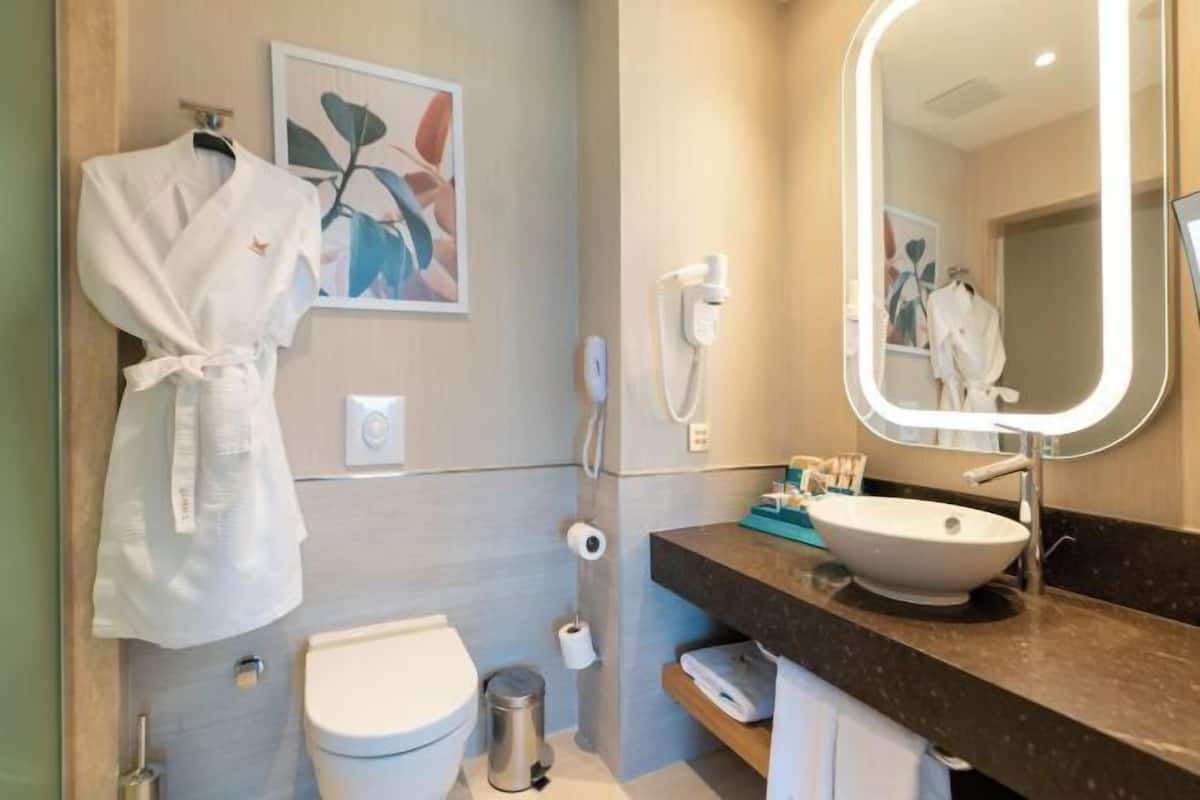 Bathroom | Eco-friendly toiletries, hair dryer, bathrobes, slippers