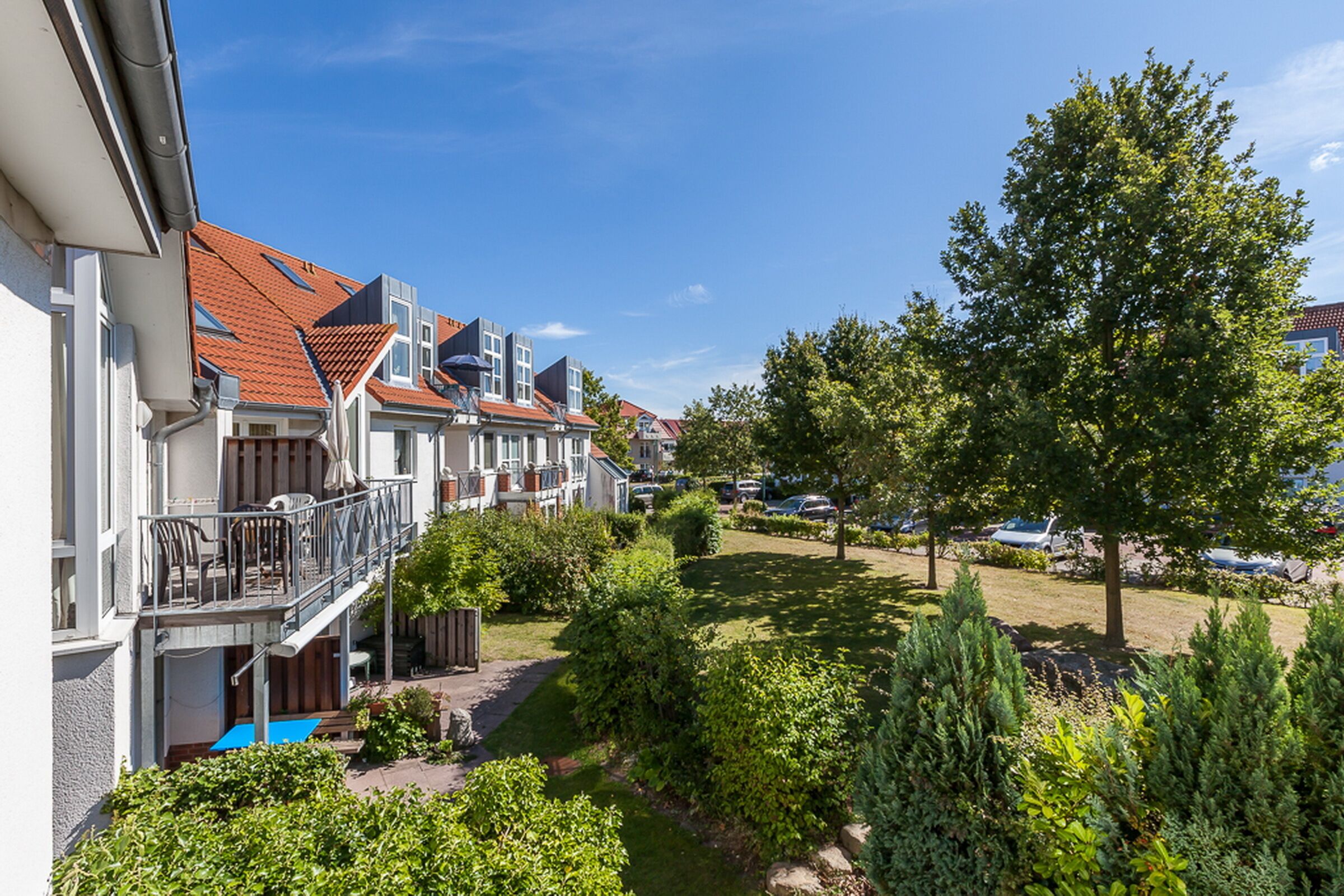 A residential area with houses, a swimming pool, and well-maintained gardens.