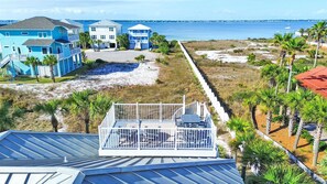 A coastal property with multiple buildings, a beach, and a view of the ocean.