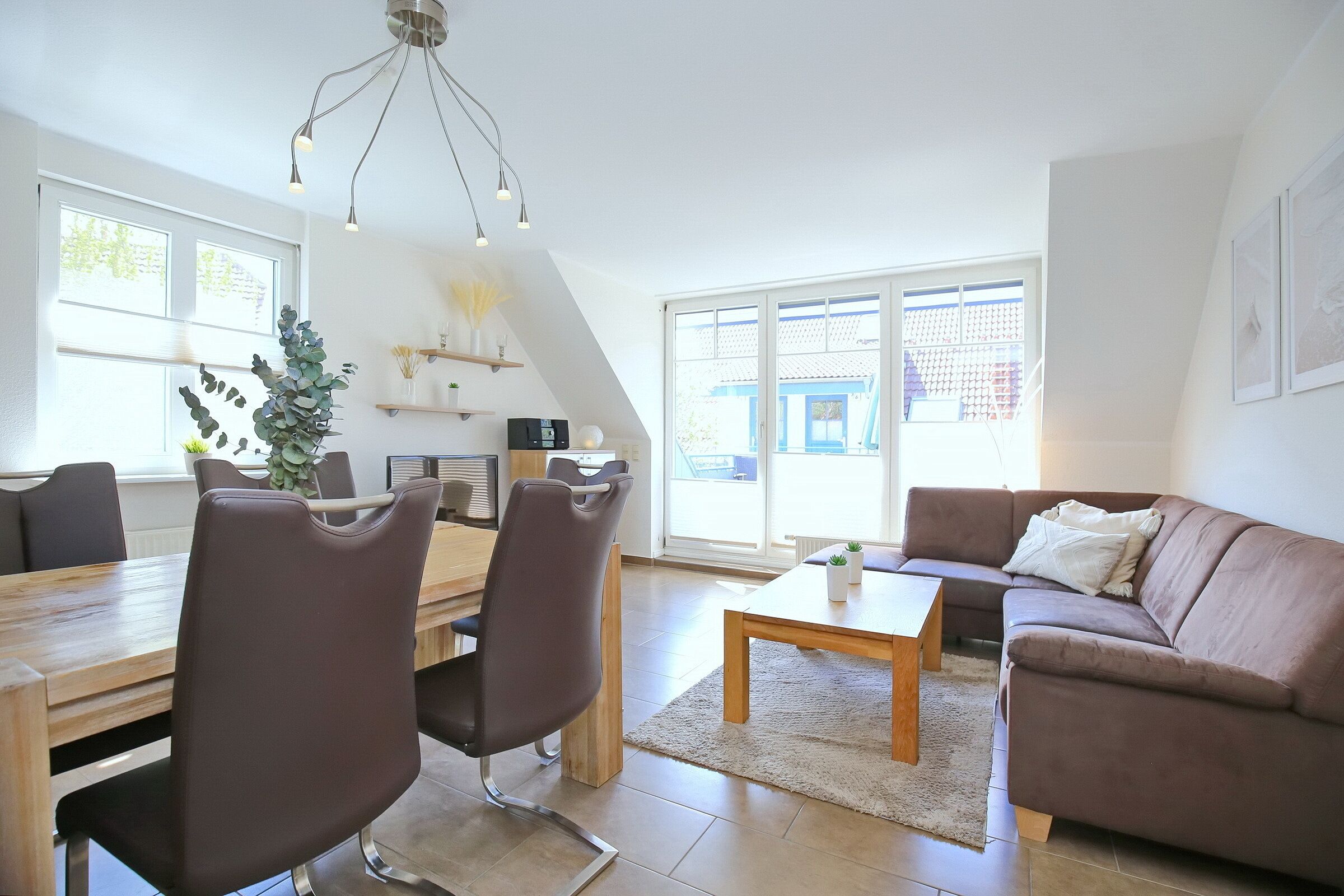 A modern living room with a dining area, a sofa, and a coffee table.