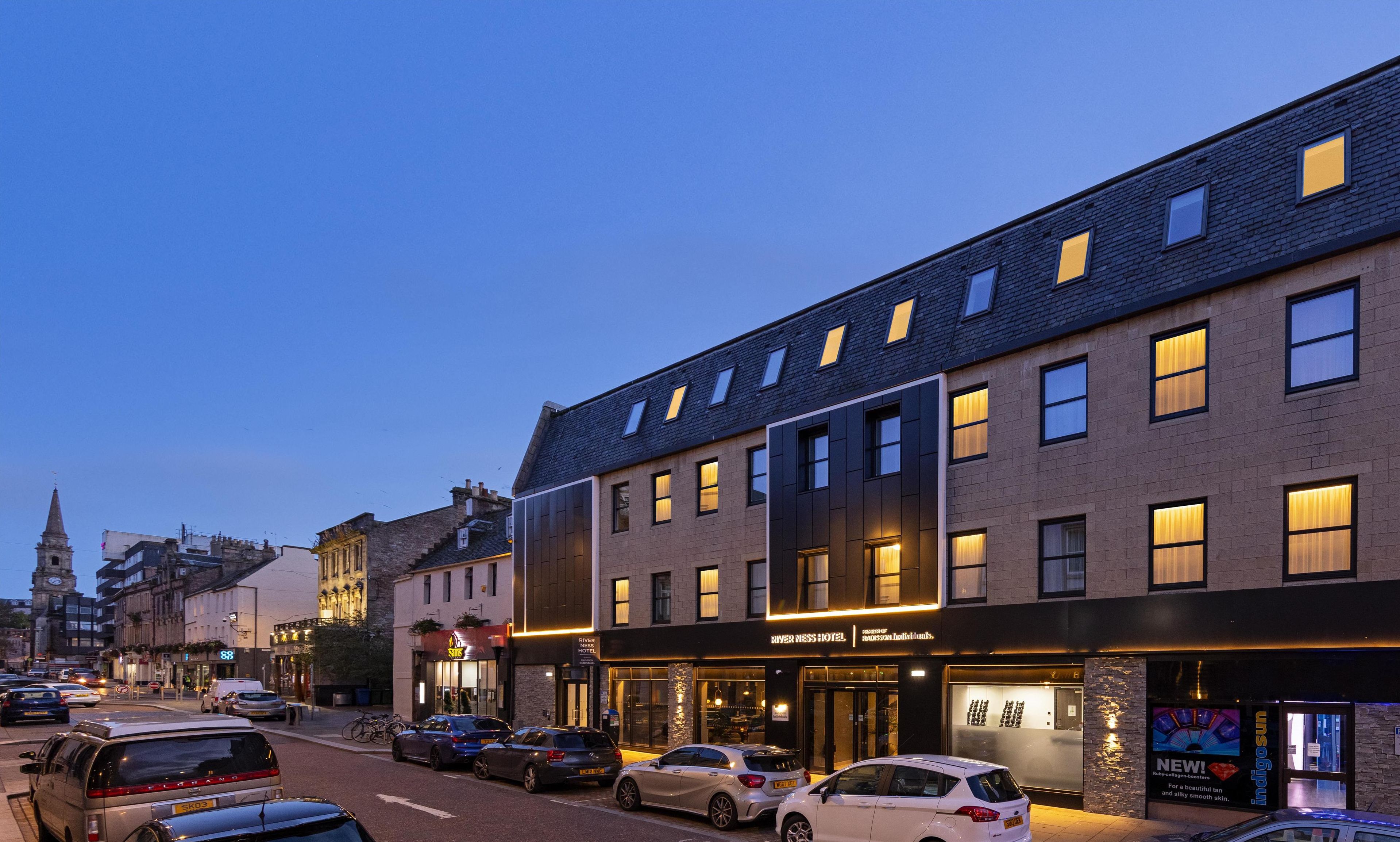 A hotel with a modern facade, large windows, and a prominent entrance.