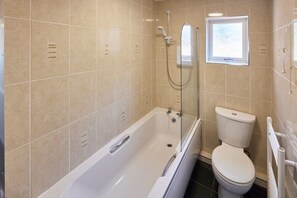 Bathtub, towels, toilet paper