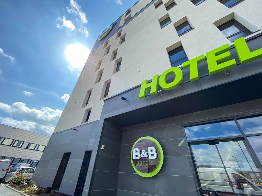 Et hotel med en moderne facade, et tydeligt 'HOTEL' skilt og en 'B&B HOTELS' logo.