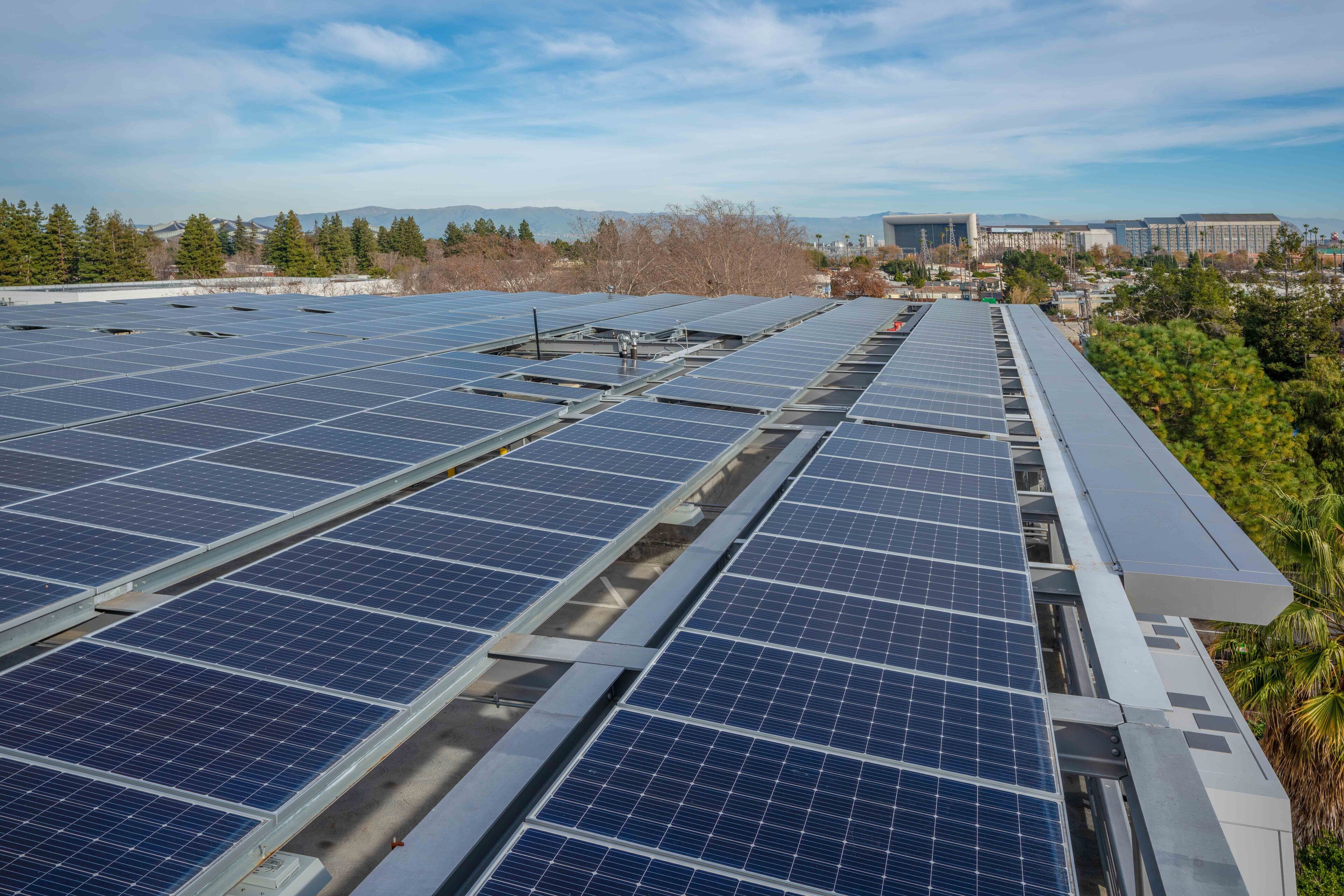 A rooftop with multiple rows of solar panels.
