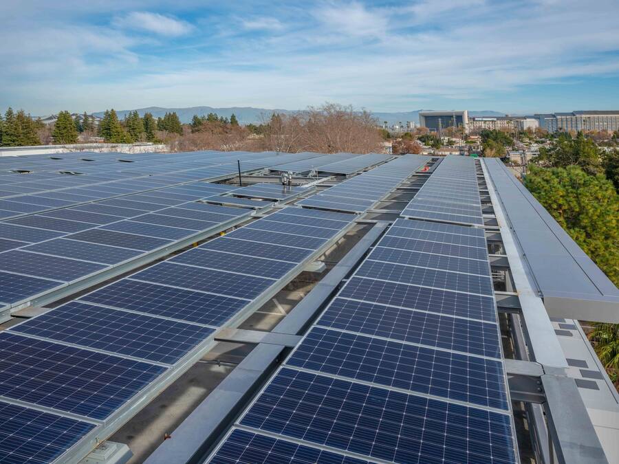 A rooftop with multiple rows of solar panels.