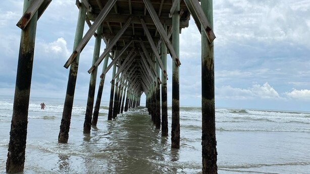 A pier extending into the sea with a clear view of the water and sky. - Beautiful Second Floor 2-Bedroom Two-Bath Condo With Water and Golf Views (Calabash)